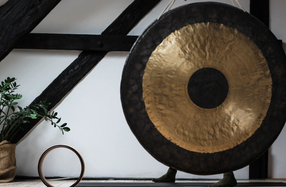 picture of a golden gong with charcoal outline on a white background